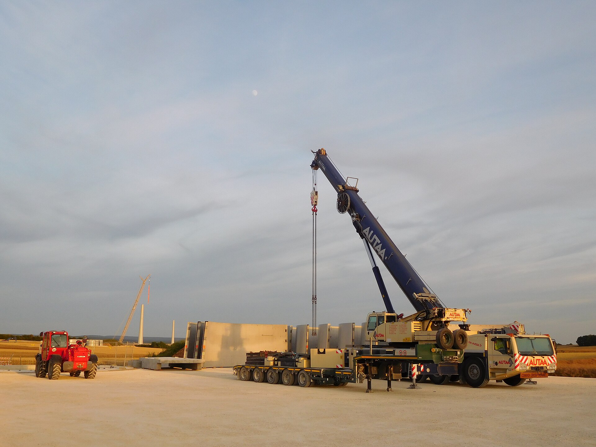 Fleet of heavy cranes at industrial construction site