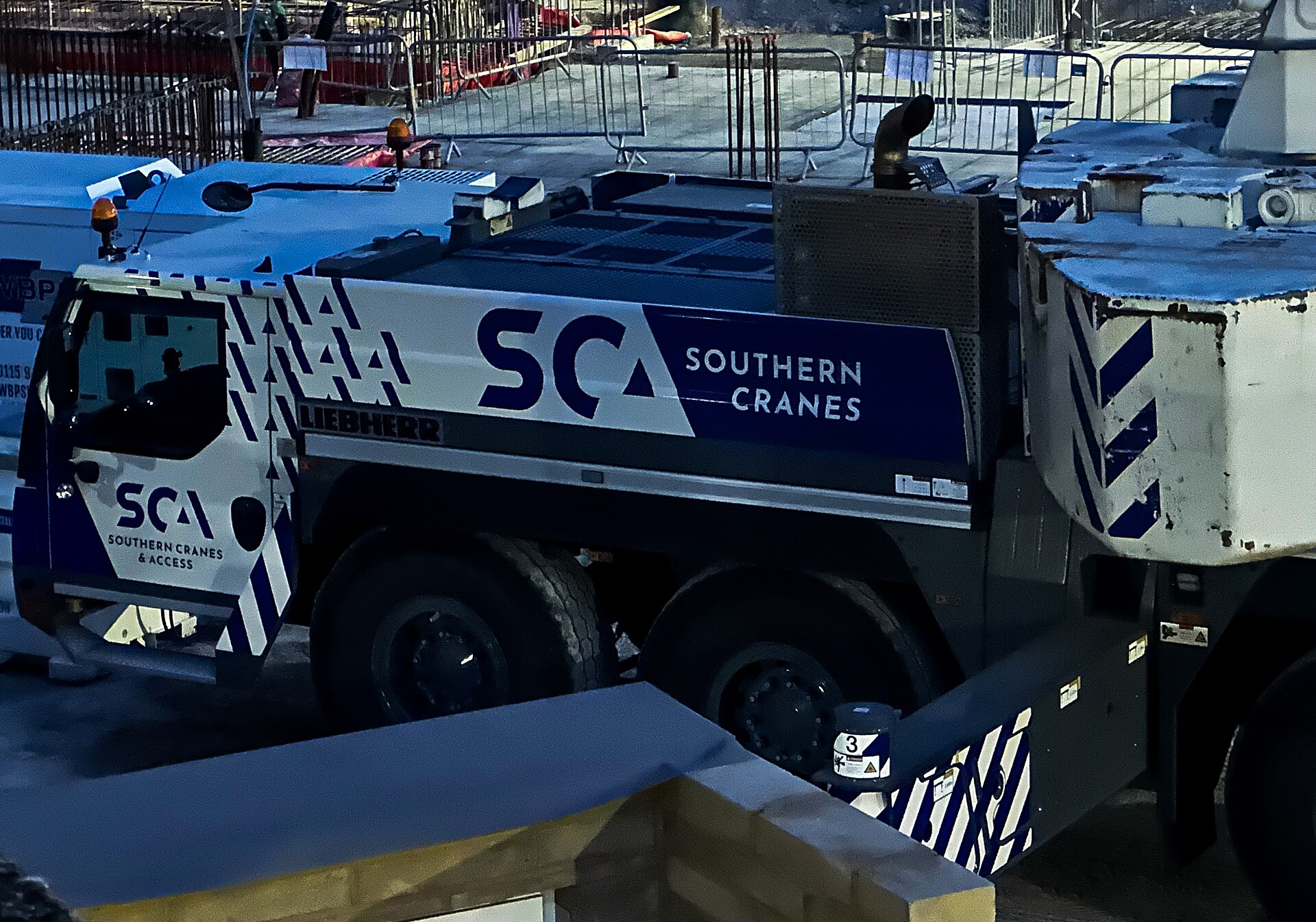 High capacity mobile crane operating at industrial construction site